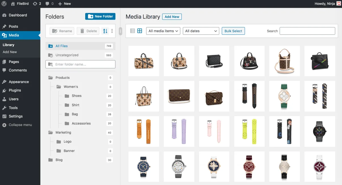 FileBird WordPress media library admin showing a Folders sidebar with Products, Womens, Shoes, Shirt, Bag, Accessories and Marketing folders next to a grid of bag and watch product images