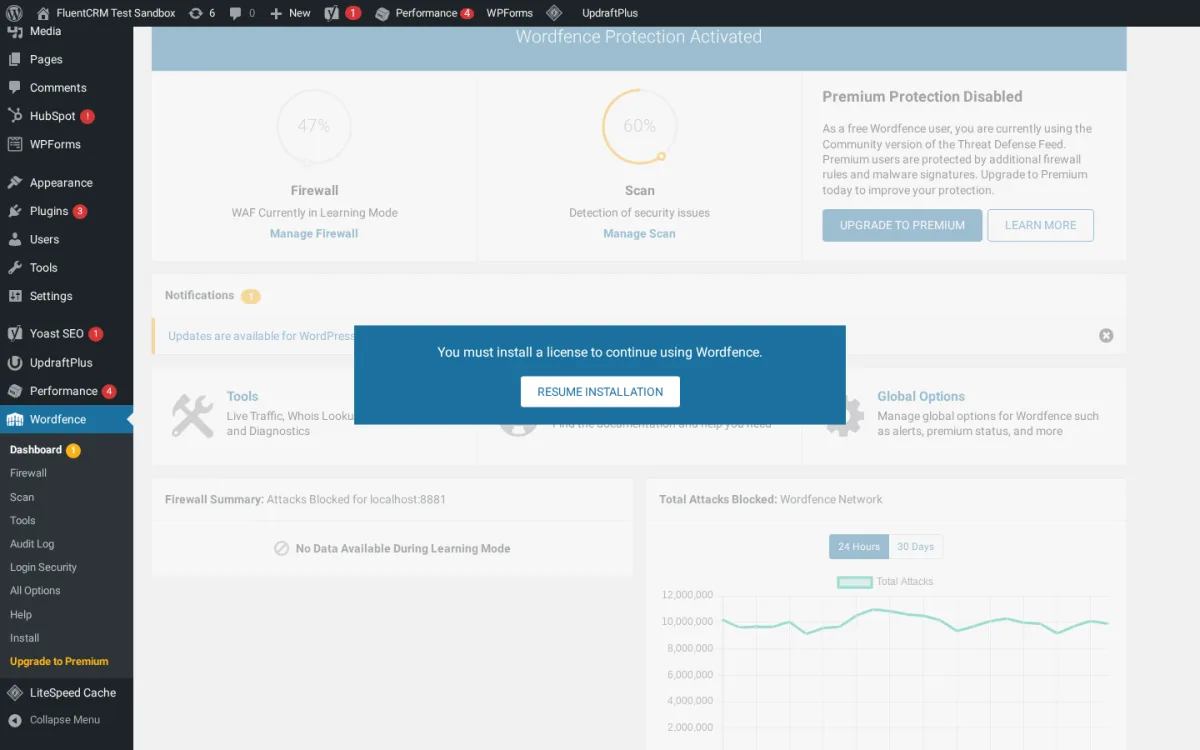 Wordfence security dashboard in WordPress admin showing the firewall status, scan status, free Community-tier protection, and total attacks blocked graph.