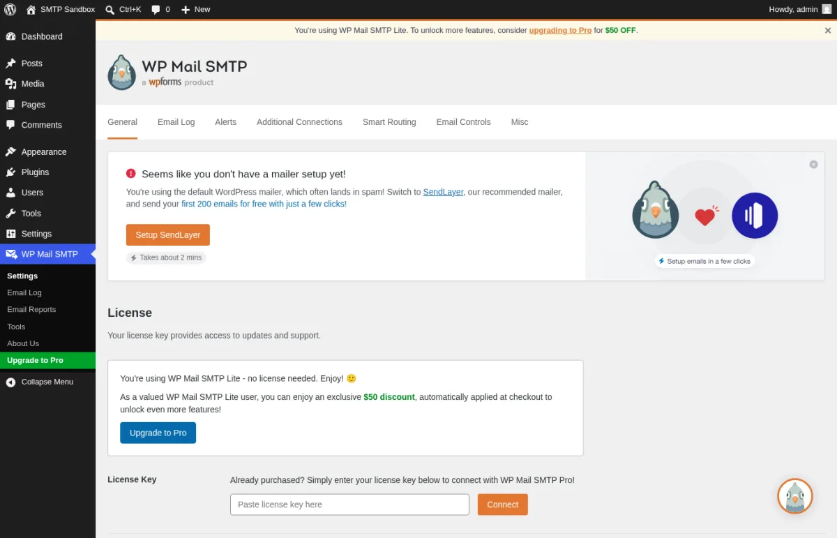 WP Mail SMTP Lite 4.8.0 General Settings tab inside a real WordPress install showing the seven tabs (General, Email Log, Alerts, Additional Connections, Smart Routing, Email Controls, Misc), the License panel reporting You're using WP Mail SMTP Lite - no license needed, the Upgrade to Pro banner with $50 discount, the License Key field, the Primary Connection block with the Setup Wizard Launch button, the From Email field with the WordPress default wordpress@127.0.0.1 placeholder, and the Force From Email toggle.